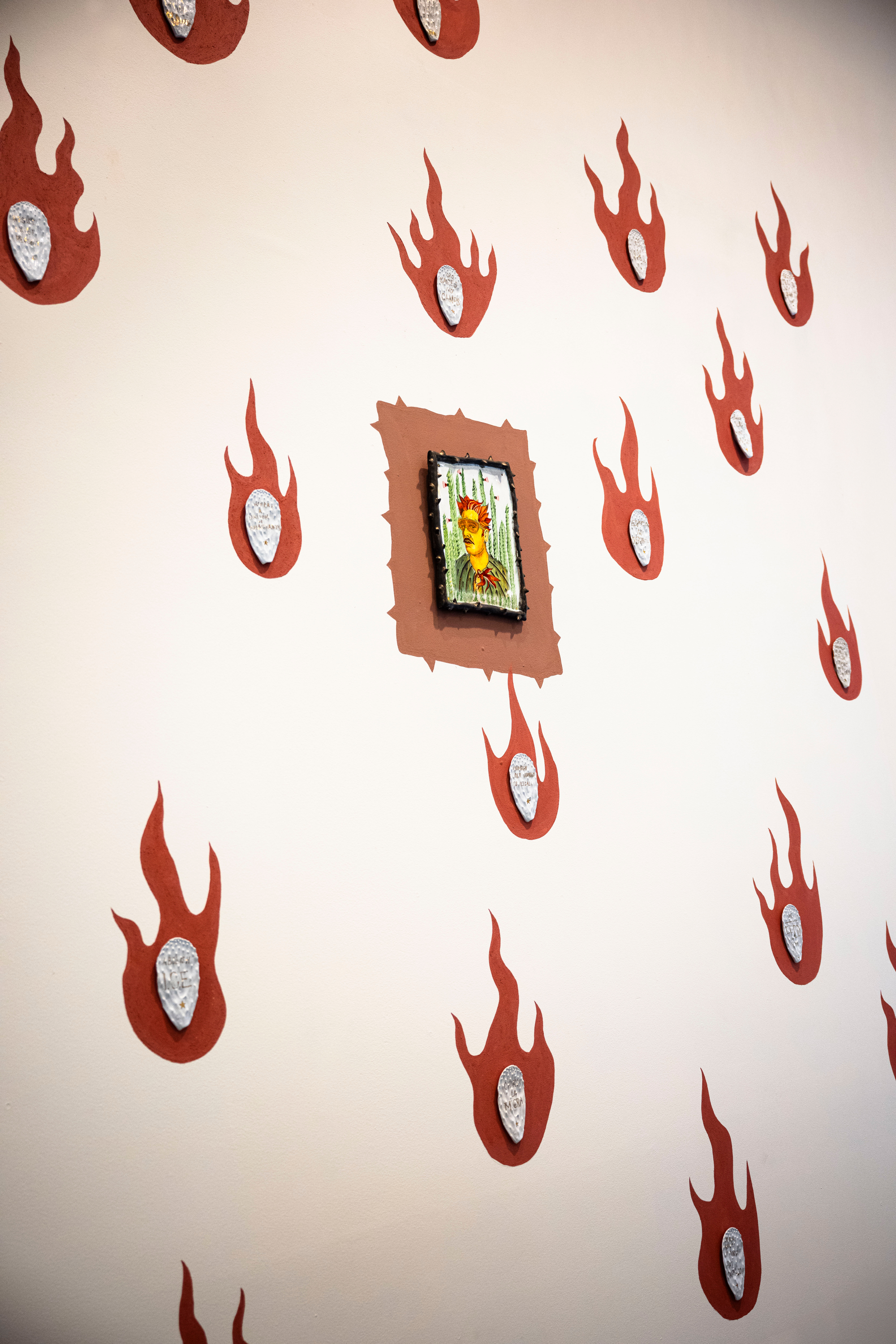 Salvador Jimenez-Flores clay slip mural with fire and a portrait in the center