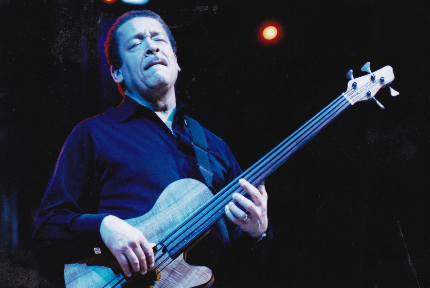 John Lee playing a bass guitar