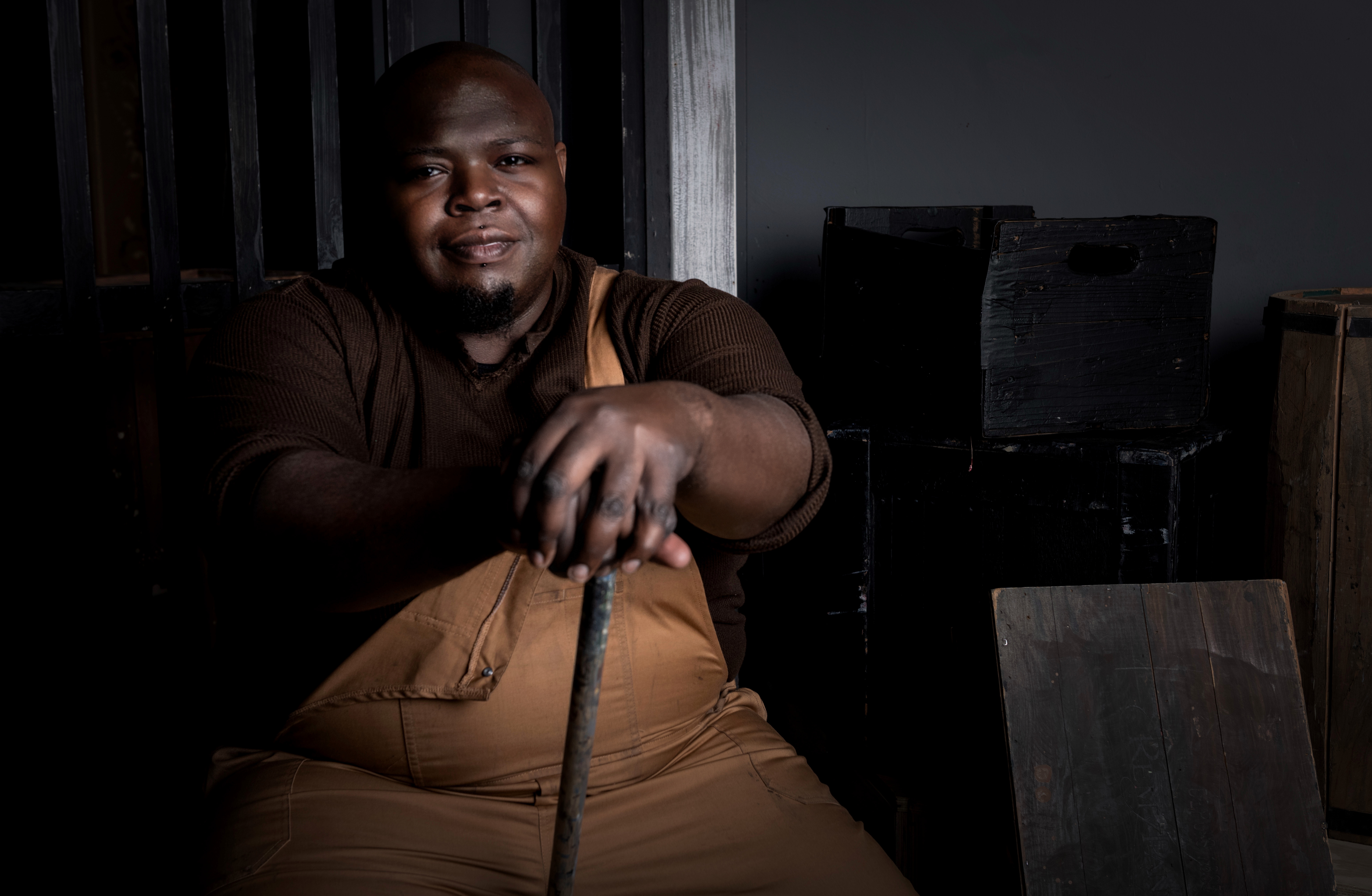Actor from Porgy and Bess sitting down with a cane in both hands
