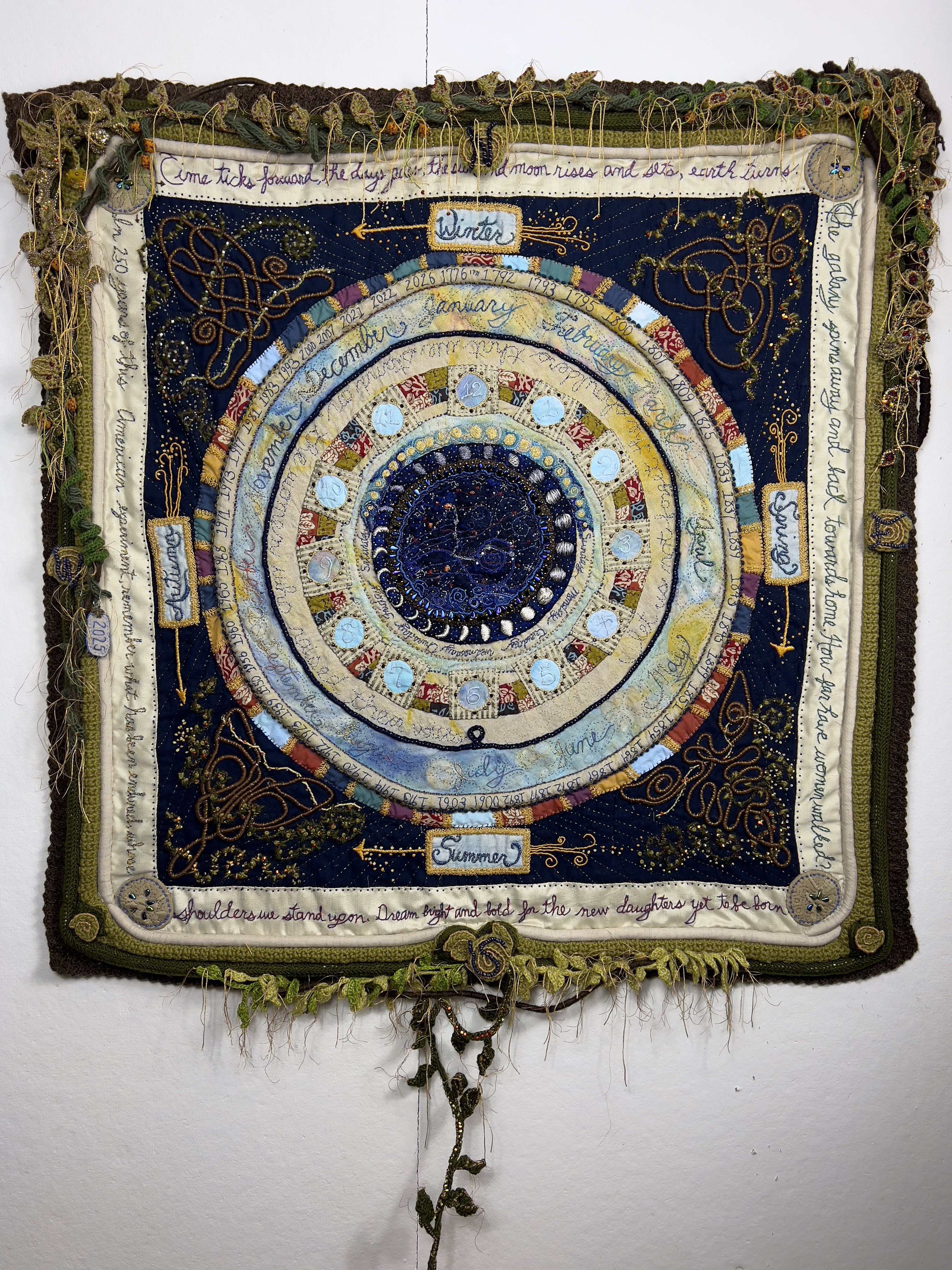 large quilt with vines, stars, and time themes