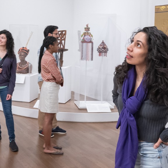 Woman looking at an art piece inside of a museum