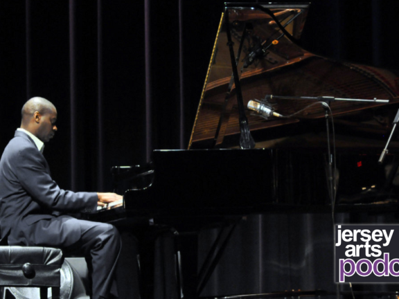 James Austin Jr. sits at a grand piano playing music