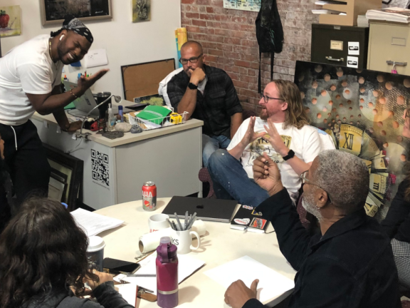 ArtWorks Trenton employees discussing the Art All Night event