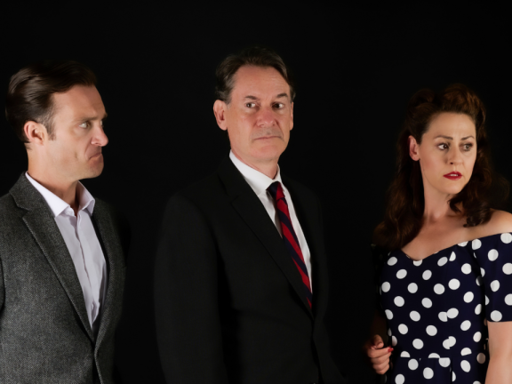 Three actors standing side-by-side with a black background