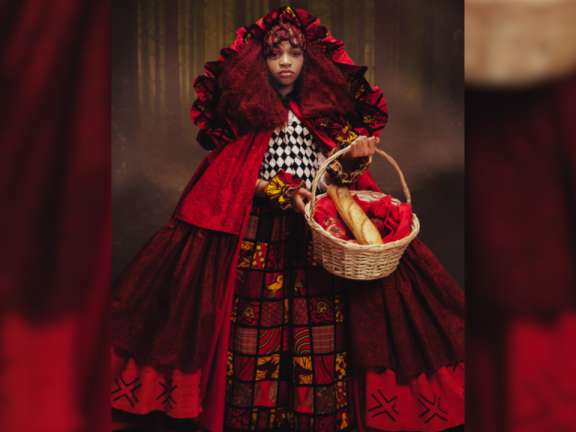 A woman in a red dress holding a basket with bread inside