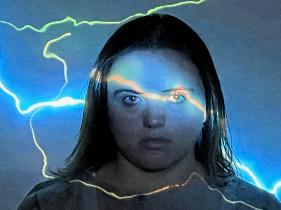A woman with lightning projected across her face