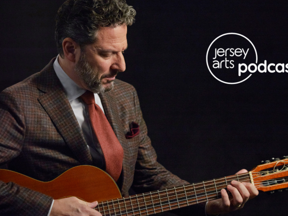 John Pizzarelli playing the guitar