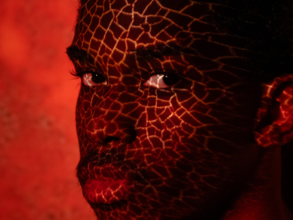 Man in red paint looking at the camera