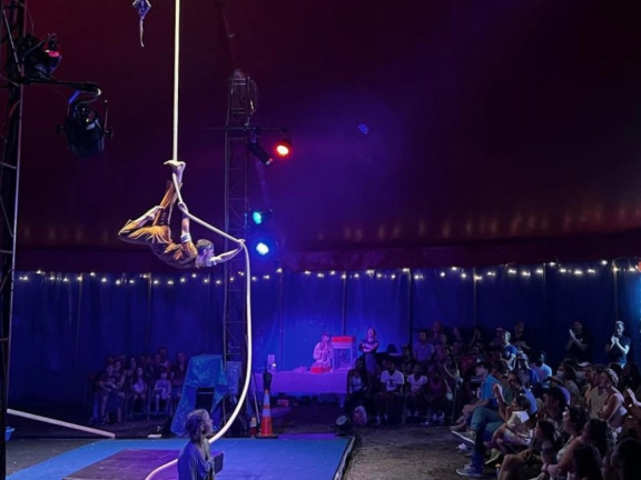 Performer suspended by rope