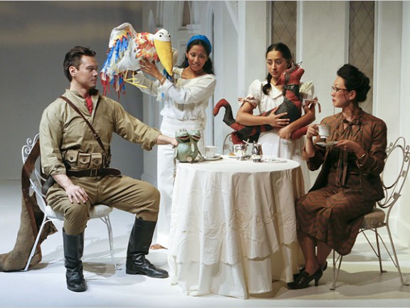 Actors performing around a table