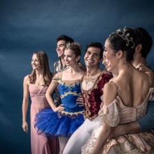 a group of ballerinas posing in their performance costumes
