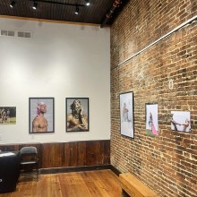 An art gallery with exposed brick and art on the walls
