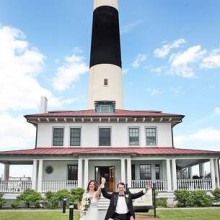 bride and groom celebrating wedding while leaving a lighthouse