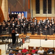 A choir performs in front of an audience in a church
