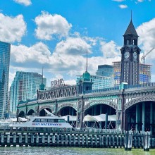 The Lackawanna Railroad Terminal in Hoboken, New Jersey and surrounding water on a bright, sunny day