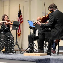 A small group of people playing musical instruments