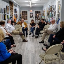 A group of people having a conversation in a gallery