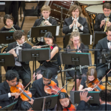 the wind and string sections performing for the Greater Princeton Youth Orchestra