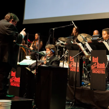 an orchestra performing in front of a screen