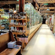 Interior of arts emporium featuring cases of artworks