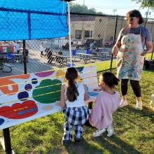A group of children painting a bench in a park