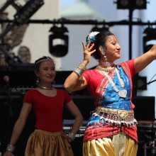 A woman performs an Indian classical dance on stage
