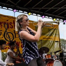 A woman playing a trumpet on stage