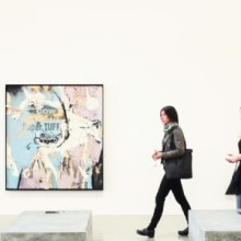 A group of people looking at art in an art gallery