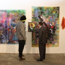 Two men looking at artwork