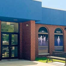 Exterior of the Camden County Arts building, a brick building with large arched windows