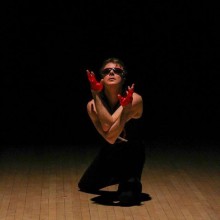 dancer wearing red gloves and sunglasses posing
