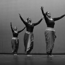 Three Indian dancers performing in a black and white photo