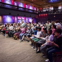 An audience facing a stage