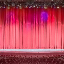 An interior of large and empty bright red performance hall