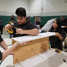 Young people working with wood.