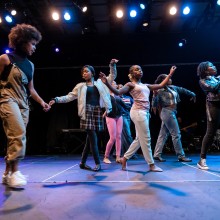 A group of young people dancing on a stage at NJPAC