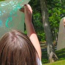 Kids from Noyes Summer Art Camp hold up their artopwrk