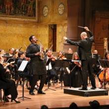 The Princeton Symphony Orchestra on stage with a conductor