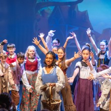 Performing Arts School students in a performance of Beauty and the Beast in costume.
