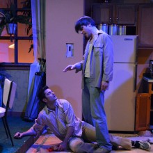 Two men on a kitchen set onstage.