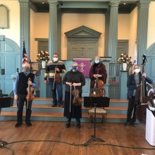 String Quintet in a church posing for a picture.