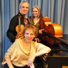 Trio of musicians at a piano.