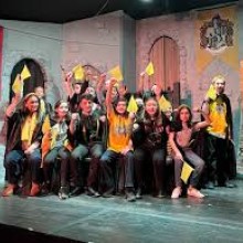Cast of youth actors onstage.