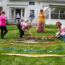 A group of women working on a craft project on a lawn