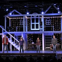 Cast performing in "Next to Normal" on a framed outline of a house.