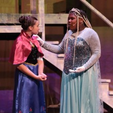 Two youth actors perform in "Frozen, Jr." on stage.