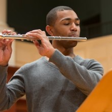 Male musician playing the flute.