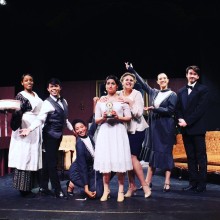 A cast from Progressive Theater posing on stage