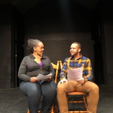 Two actors from Progressive Theater rehearsing on stage