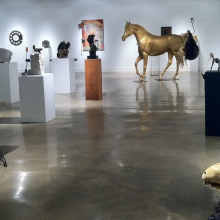 An art gallery with various sculptures on display.